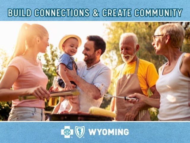 Photo of a family enjoying a bbq in the summer sun with BCBSWY logo